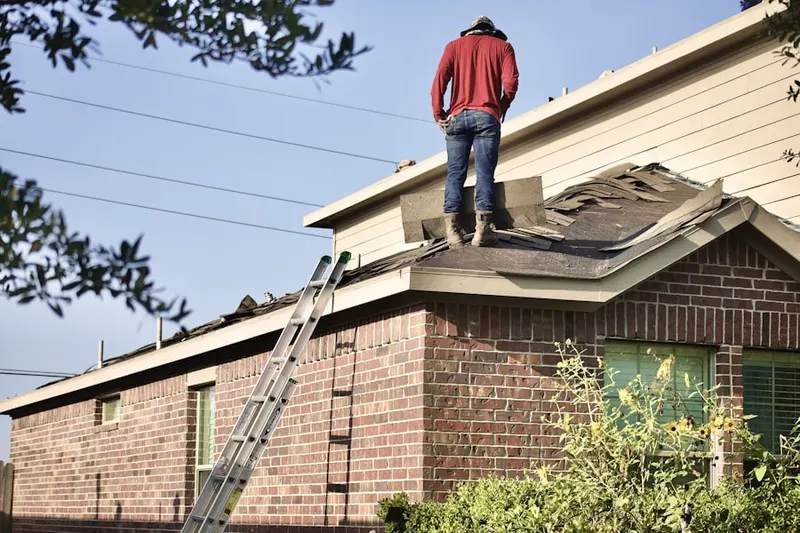 Professional roofer working on a residential roof in Bonneville